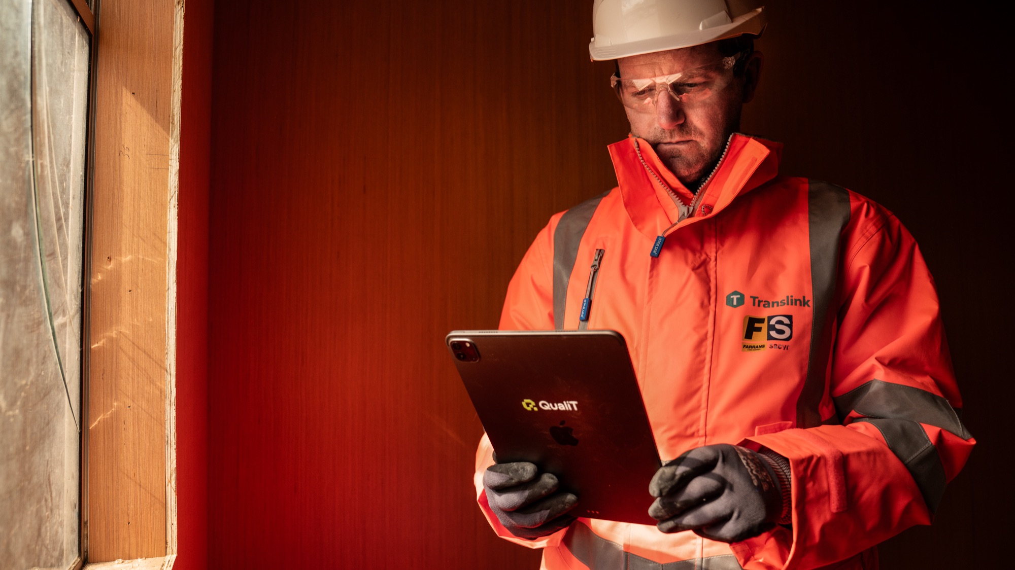 A site operative using the QualiT app on a tablet