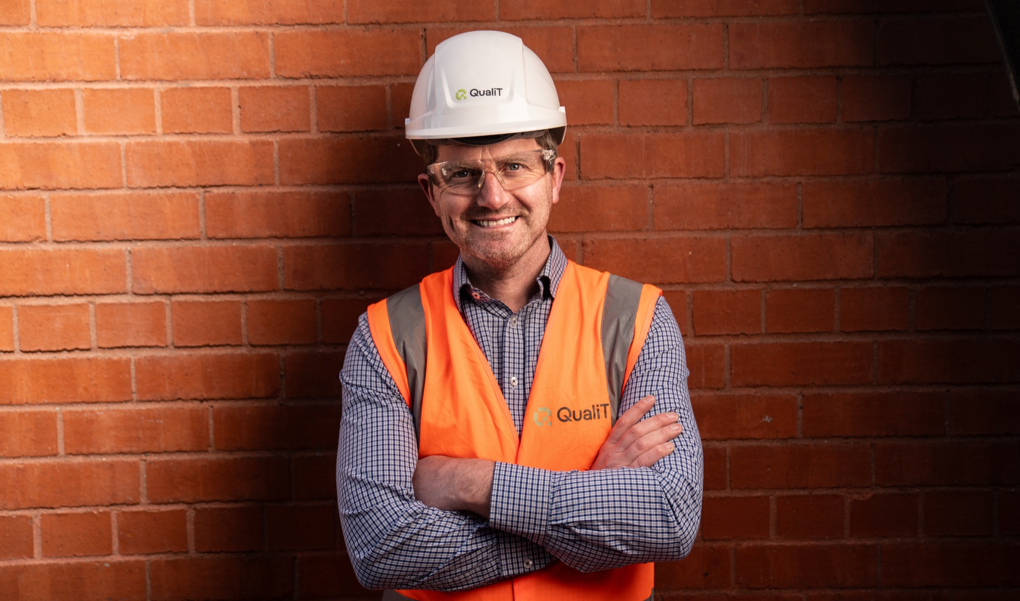 A QualiT-branded construction professional on site